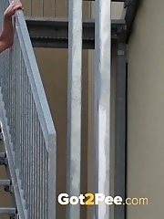 15 pictures - Sexy brunette pees on the aluminium steps