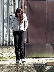15 pictures - Gorgeous brunette filmed twice pissing outside