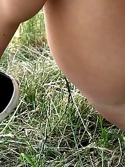 15 pictures - Blonde with plaited hair squats to piss outside