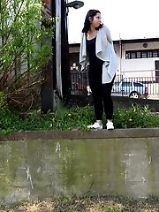 15 pictures - Dark haired girl sprinkles her piss off a ledge