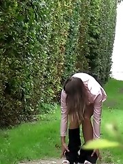 15 pictures - Pretty brunette pulls down her trousers to pee