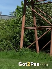 15 pictures - Brunette pissing outside to relieve herself