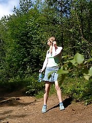 16 pictures - Nude puss playing watersports deep in the woods