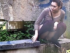 0  - Pretty brunette pisses while squatting outside