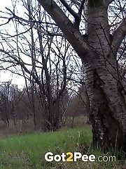 15 pictures - Pretty girl waters the grass with her golden pee