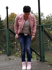 15 pictures - Dark haired girl squats to piss on decking