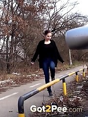 15 pictures - Brunette girl squats near a car to piss outside