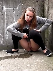 15 pictures - Hot brunette pisses in the middle of the city