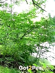 15 pictures - Cute brunette pisses next to the riverbank