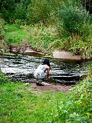 16 pictures - Spying after a cute babe peeing on the river beach