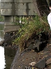 15 pictures - Dark haired girl pisses next to a flowing river