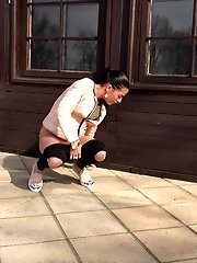 15 pictures - Dark haired babe squats to piss outside