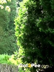15 pictures - Girl lifts her dress and pees into a river