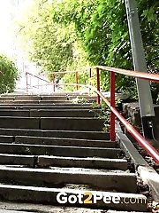 15 pictures - Brunette babe squatting to pee on some steps