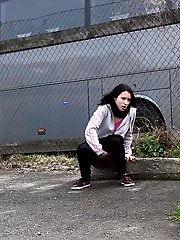 15 pictures - Dark haired girl pisses by a public car park