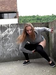 15 pictures - Hot brunette pisses in the middle of the city