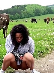15 pictures - Dark haired girl pisses on the grass outside