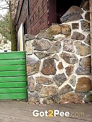 15 pictures - Pretty babe pisses onto a wooden terrace