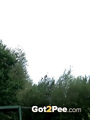 15 pictures - Hot brunette pisses next to a local pond