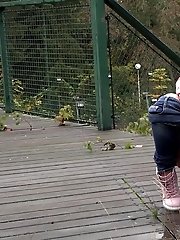 15 pictures - Dark haired girl squats to piss on decking