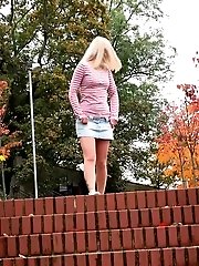 15 pictures - Pretty blonde squats on steps outside to piss