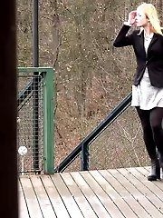 15 pictures - Blonde in pantyhose pisses on wooden decking