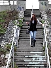 15 pictures - Sexy brunette babe pisses in public on some steps